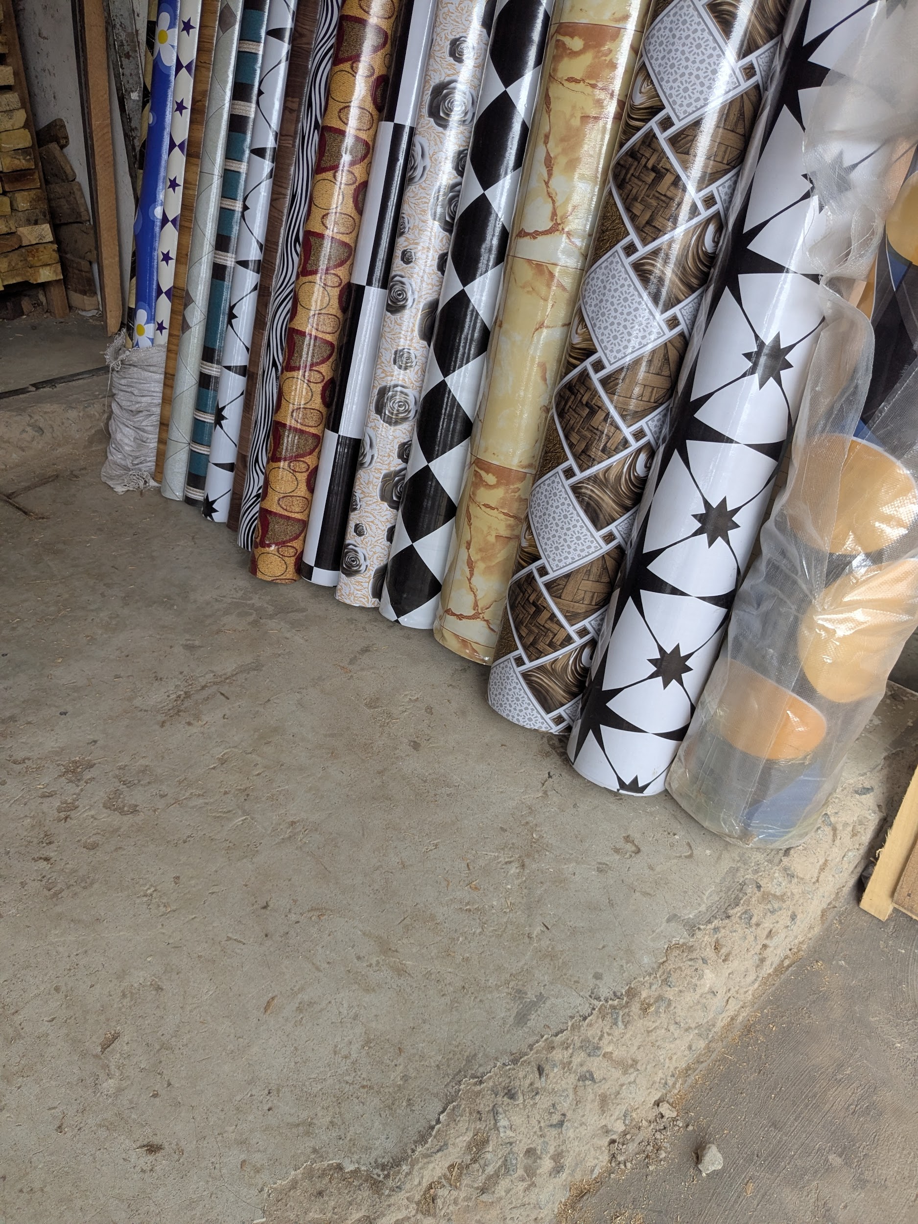 Rolls of plastic sheeting and waterproofing materials available at a local market stall
